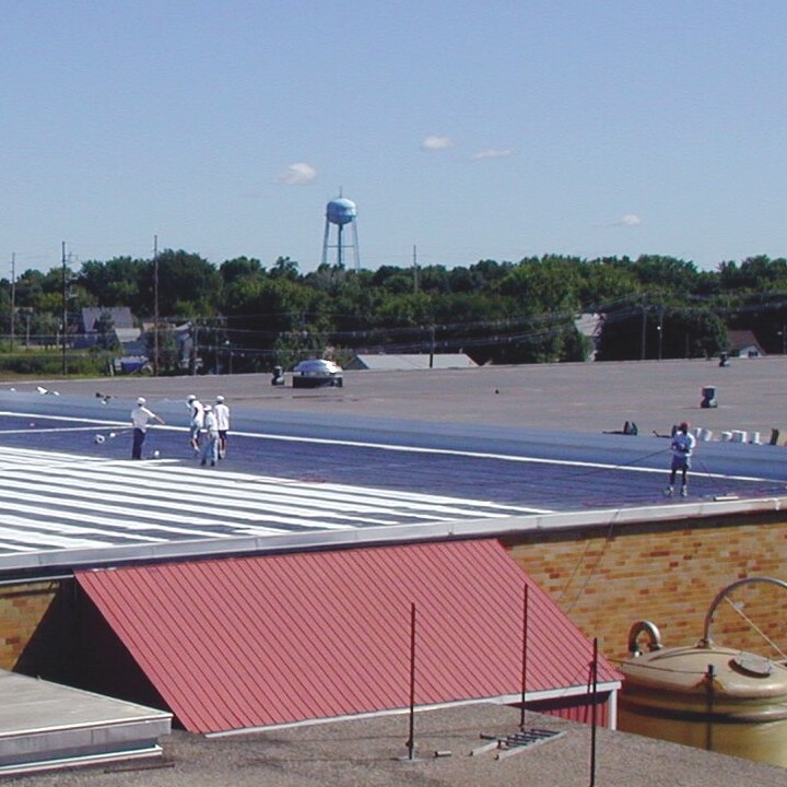 Roofers Applying a Membrane Roof Coating.