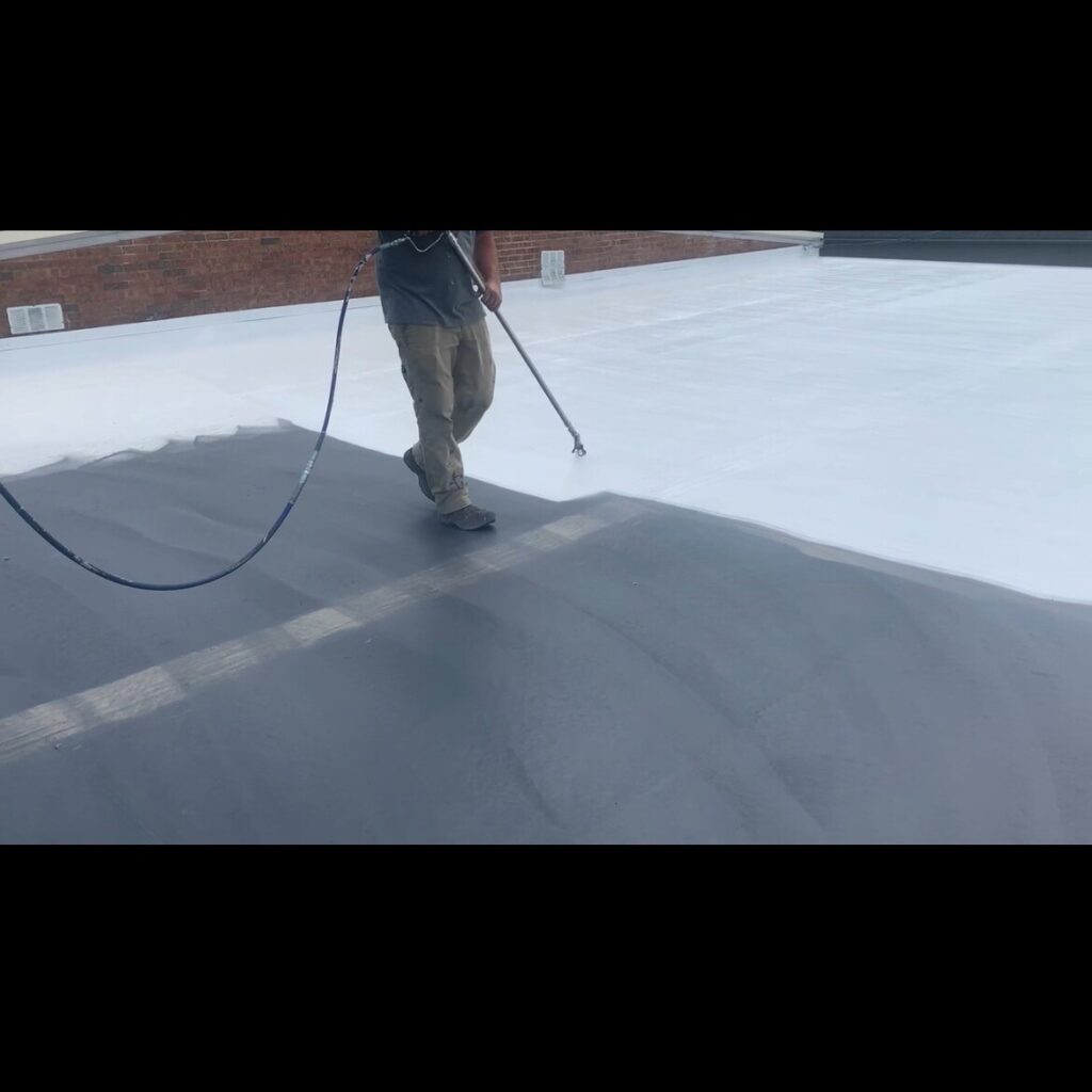 close up of roofer spraying a roof