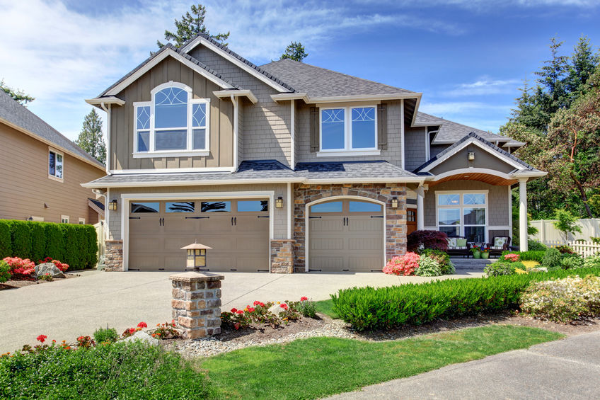 Home exterior with garage and driveway with nice landscaping desing around