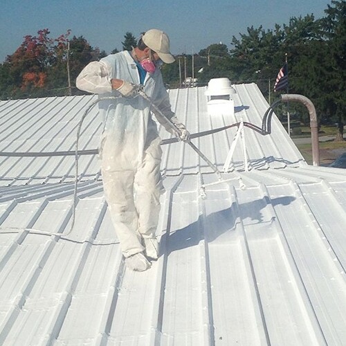 A Roofer Applies Metal Roof Coating