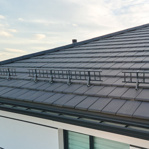 close up of metal shingle roof with snow guard